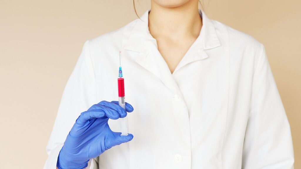 Woman doctor holding syringe