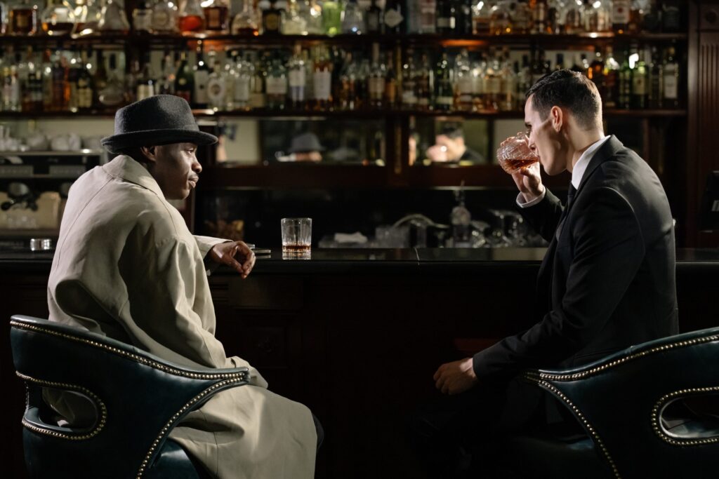 Detective and man sitting at bar