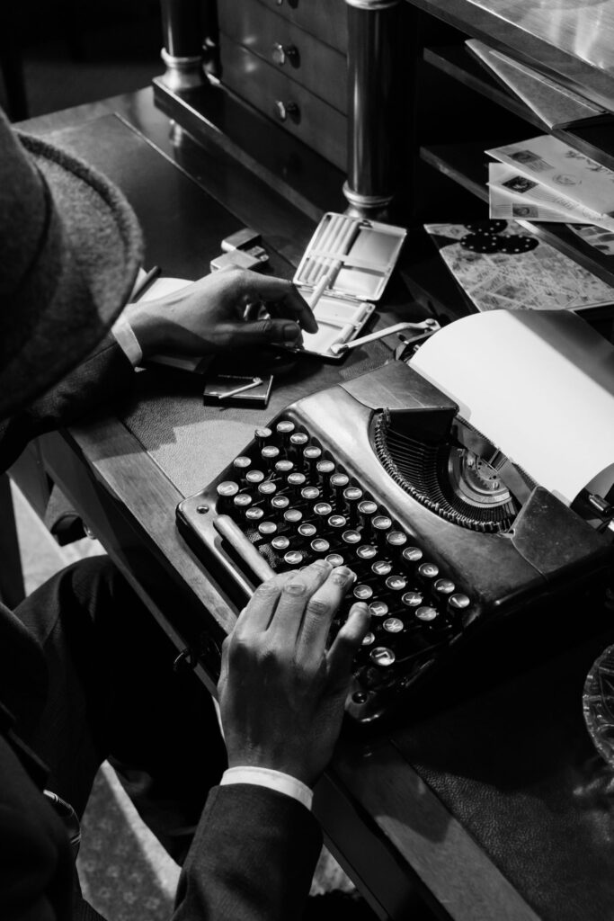 Black and white image of hands at a typewriter