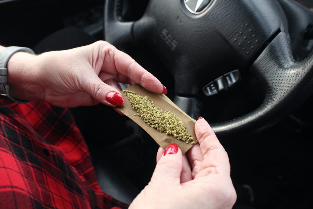 Woman holding marijuana in car