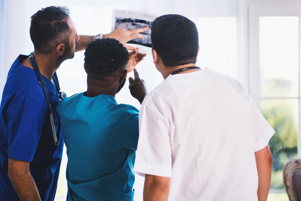 Group of healthcare professionals examining x-ray