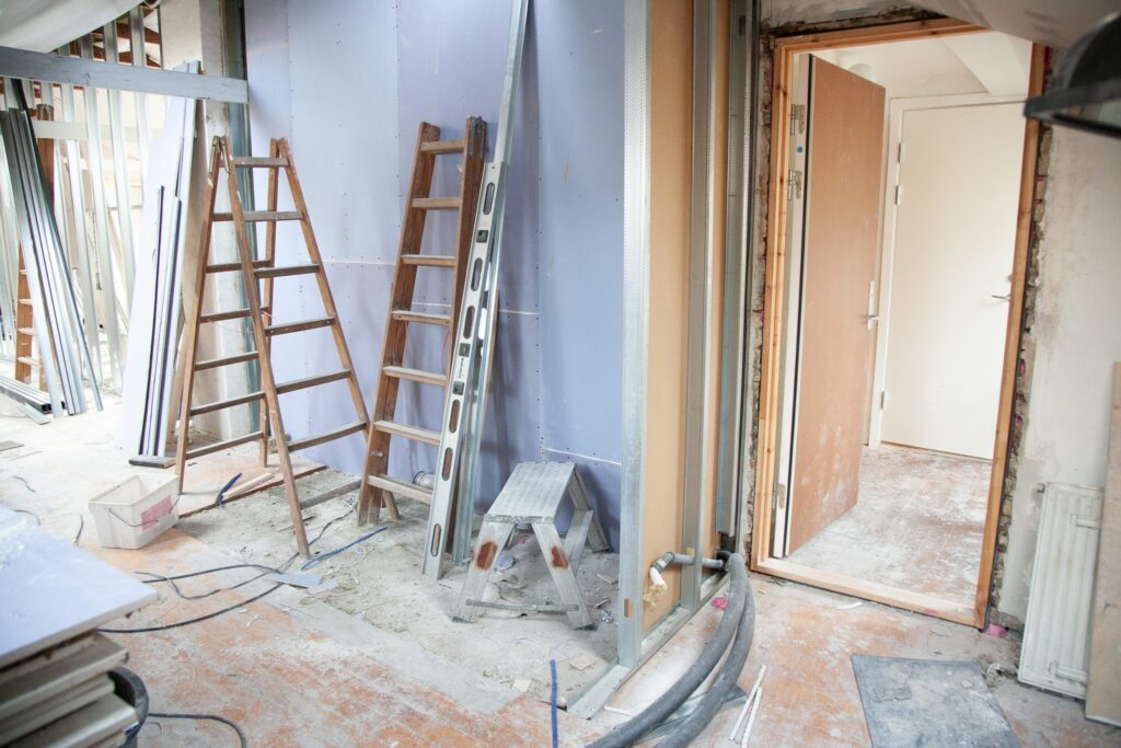Ladders and painting supplies in a room undergoing renovations
