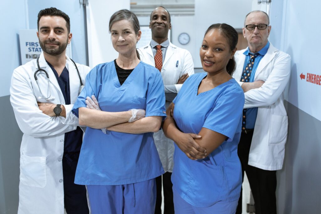 Team of medical professionals smiling with arms crossed