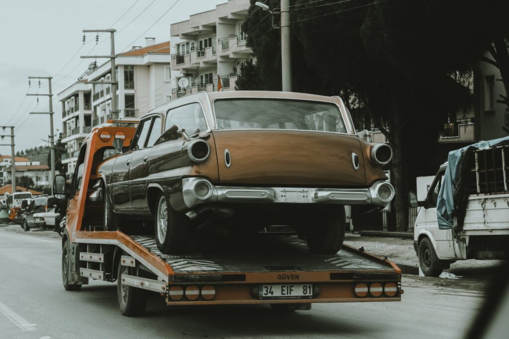 Photo of vintage car being towed